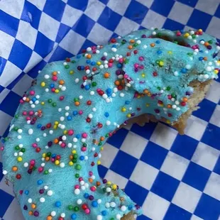 a half eaten donut with sprinkles