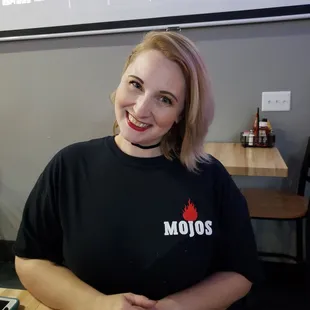 a woman sitting at a table in a restaurant