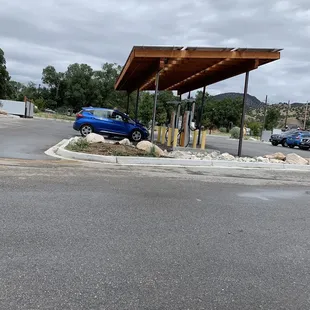 Electric vehicle charging station viewed from outdoor tables / patio area.  There is a little road noise with the close proximity to Hwy 50.
