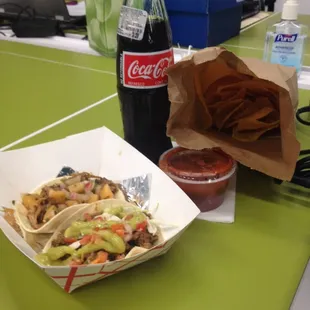 Carne asada, carnitas tacos; chips and tomato salsa, Mexican coke. Yay for free lunch at work!