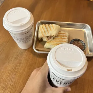 a person holding a cup of coffee