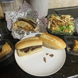 12 inch cheesesteak ($7.69), chicken Caesar salad ($7.49), baklava ($2), and gyro pita ($6.49)