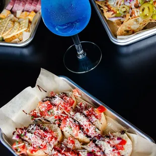 a tray of pizza and a drink