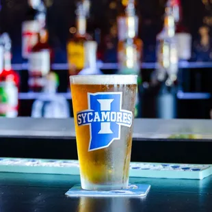 a pint of beer on a bar