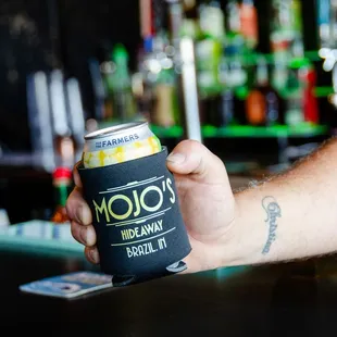 a man holding a can of soda