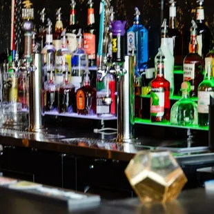 a row of liquor bottles on a bar