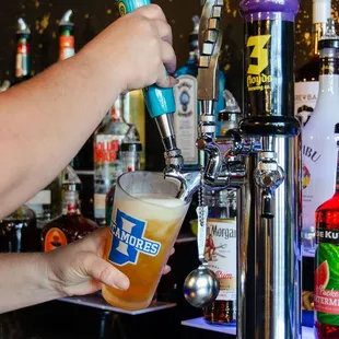 a person pouring a beer