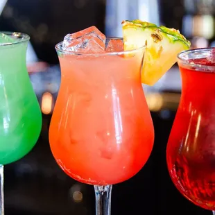 three cocktails on a bar