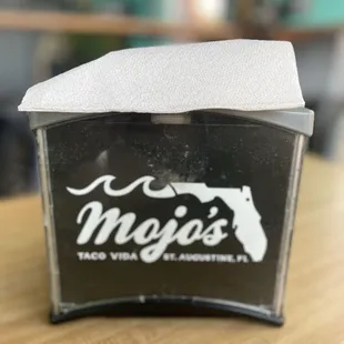 a napkin dispenser on a table