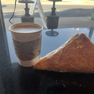 a coffee cup and a pastry