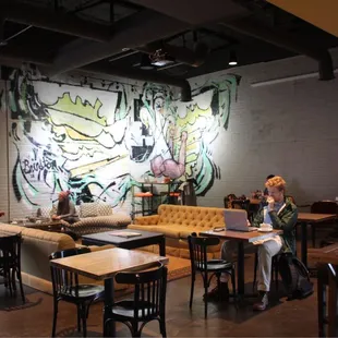 people sitting at tables in a coffee shop