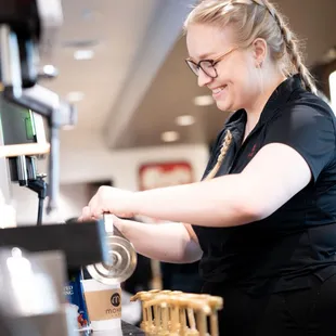 a woman pouring coffee