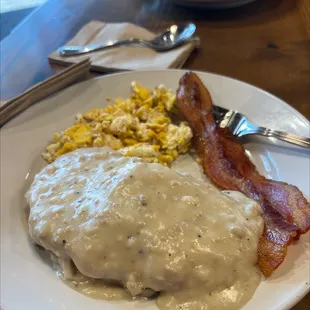 Breakfast plate with bacon and half order of biscuits and gravy