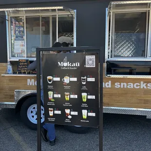 a man standing in front of a food truck