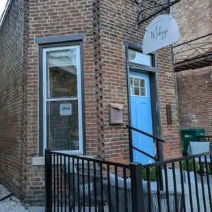 Outside of Mokey's with a path to the left for outside seating