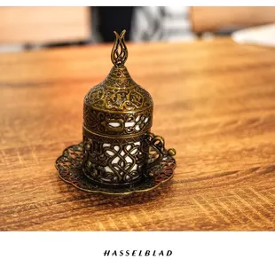 a brass teapot on a wooden table
