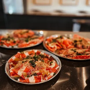 three pizzas on a table