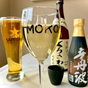 a glass of wine and a bottle of sake