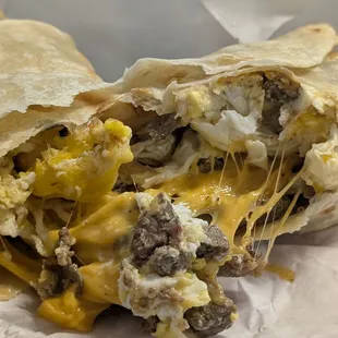 Breakfast burrito made of carne asada, eggs, cheese, and flour tortilla