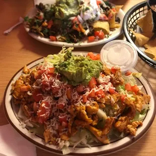Grilled chicken salad (front) and asada nachos (back)