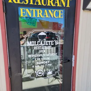 Front door with business hours.