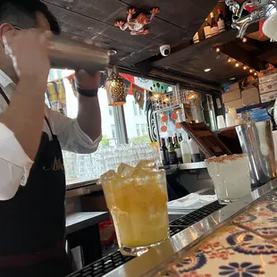 a bartender pouring a drink