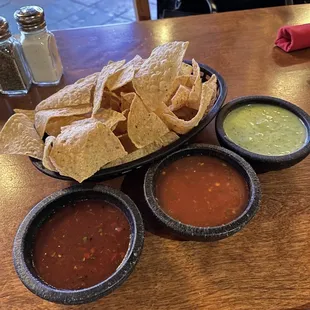 Complimentary chips and dips. It&apos;s cool that they offer three different dips.