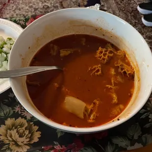 a bowl of soup and a plate of rice