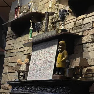a mantel with trophies on it