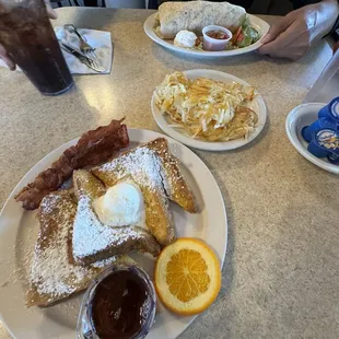 French toast and breakfast burrito with a side of hash browns.