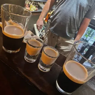 a row of beer glasses on a bar