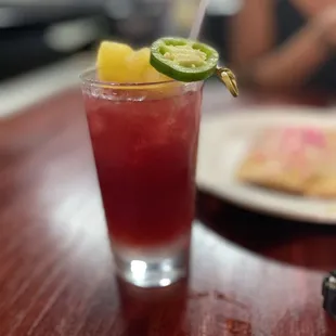 a drink with a lime garnish