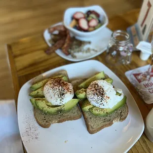 a plate of avocado toast and a cup of coffee