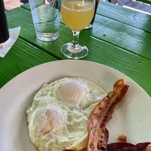 Eggs over easy with bacon and a mimosa!