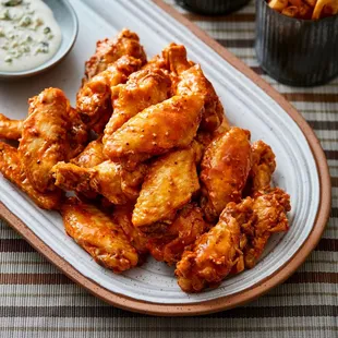 a platter of buffalo wings with ranch dip