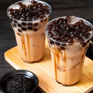 two glasses of iced coffee on a wooden tray