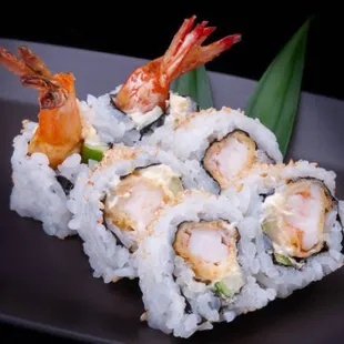 a plate of sushi with shrimp