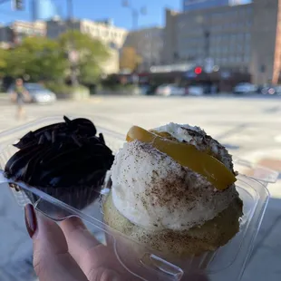 a hand holding a cupcake