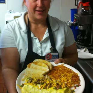 Julie serviing a Farm Boy Omelet