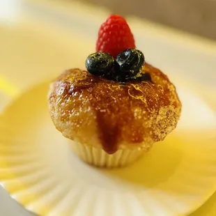 a cupcake with berries on top