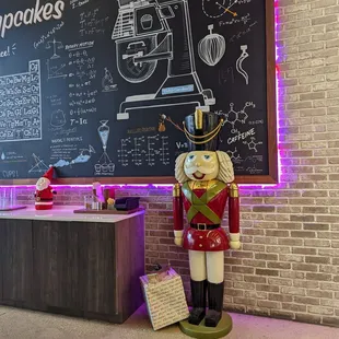 a nutcracker in front of a chalkboard