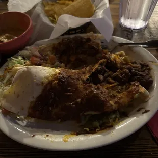 My &quot;bean&quot; burrito with red paste on top. Enchilada edible. Salsa was gross.