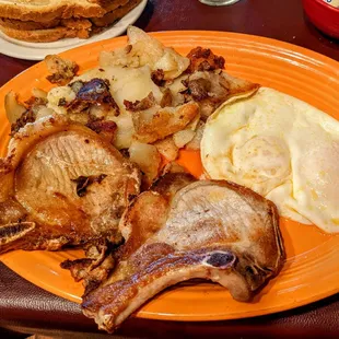 My usual pork chops eggs over easy potatoes, sourdough toast and coffee.