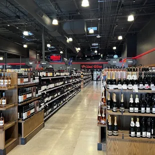a wide aisle of wine bottles