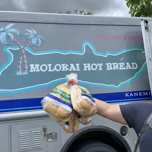 a man holding a bag of bread