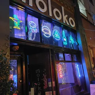 a neon sign on the front of a restaurant