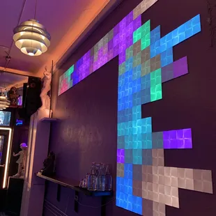 a purple wall with a multicolored pattern on it