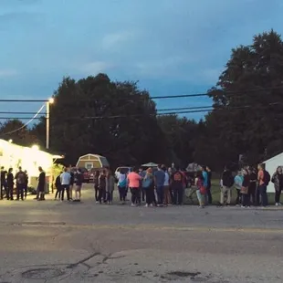 a crowd of people standing in line