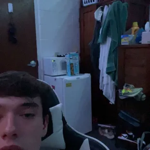 a young man in his dorm room