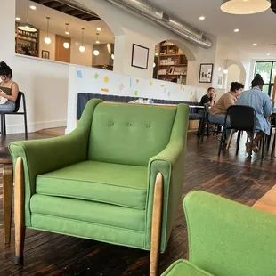  a green chair in a cafe